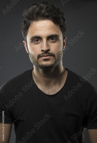 Caucasian guy wearing black T-shirt in studio  © bilalizaddin