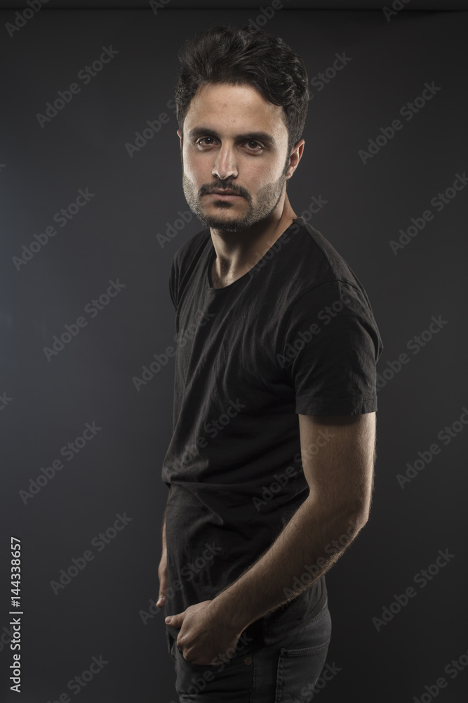 Caucasian guy wearing black T-shirt in studio 