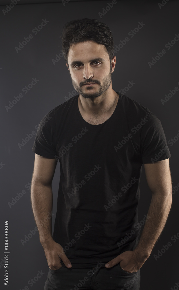 Caucasian guy wearing black T-shirt in studio Caucasian guy wearing black T-shirt in studio