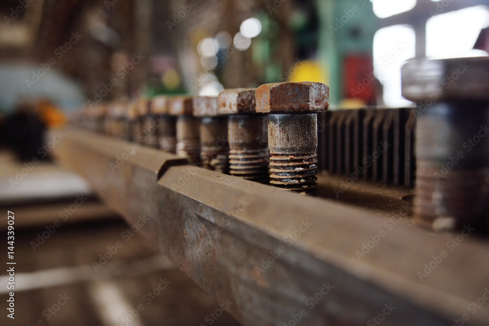 Production of bolts against the background of the plant. Heavy industry, plant, metal structures Production of bolts against the background of the plant. Heavy industry, plant, metal structures