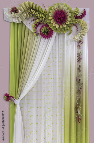 Delicate green - yellow curtains of light fabric, a tulle and luxurious flowers made from starched material.