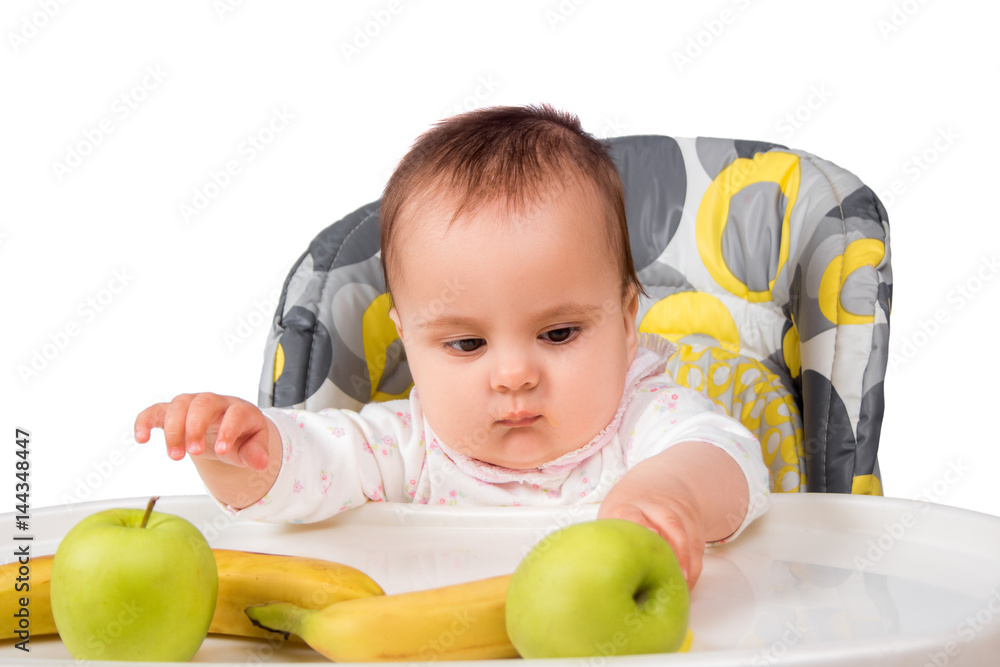 little child girl sitting at table with fruits isolated little child girl sitting at table with fruits isolated