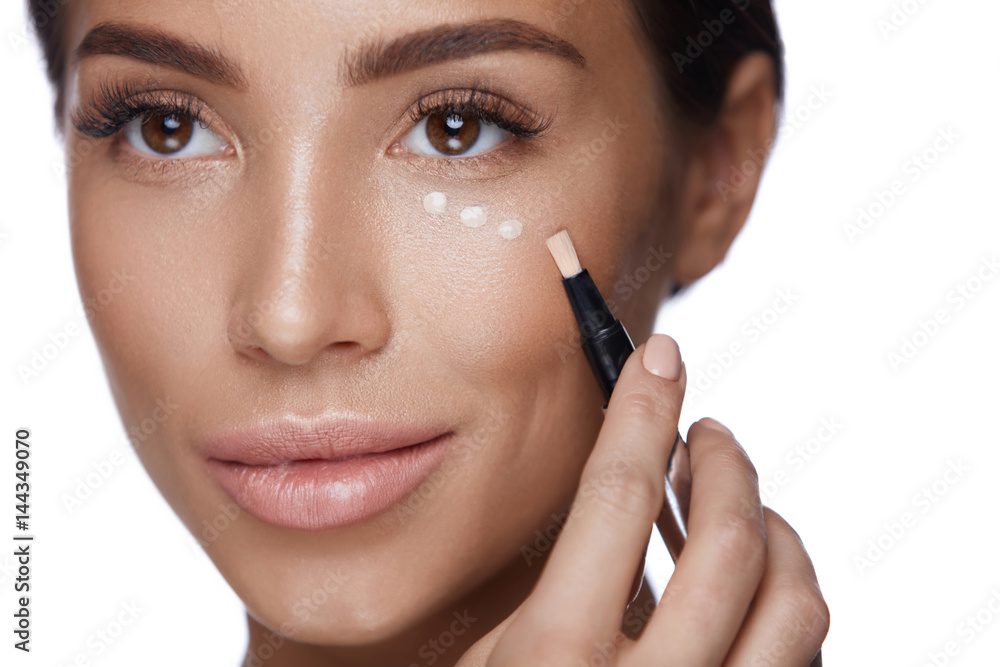 Cosmetics. Beautiful Woman Applying Concealer On Skin Under Eyes Cosmetics. Beautiful Woman Applying Concealer On Skin Under Eyes