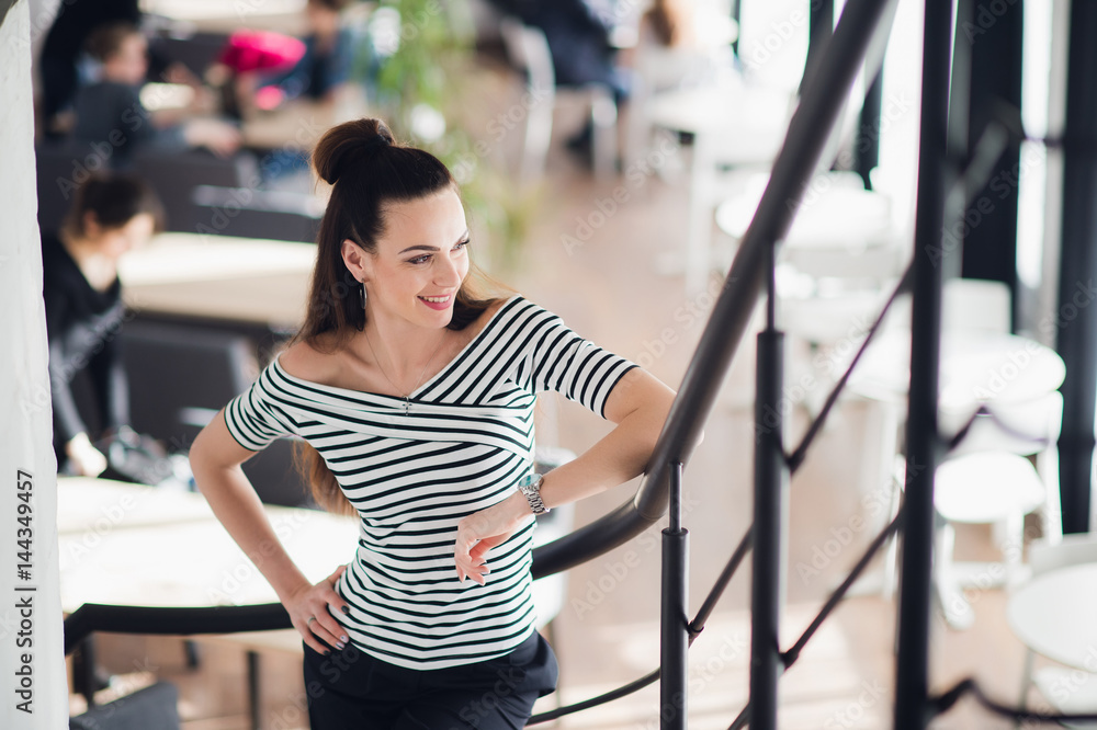 Young, beautiful and natural young woman in a cafe. Fresh and attractive female standing indoor. Young, beautiful and natural young woman in a cafe. Fresh and attractive female standing indoor.