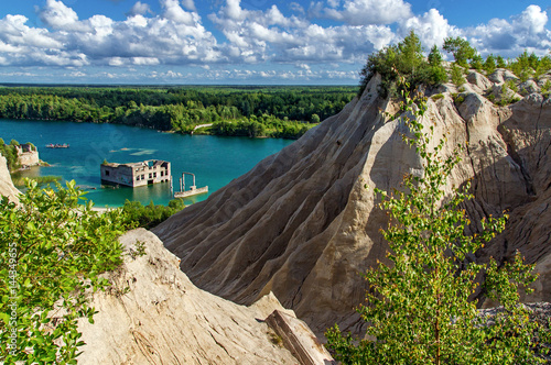 mountain, forest and turquoise lake in the village of Rummu. Abandoned quarry for extraction of limestone. Beautiful nature, attraction in Estonia. The summer season. photo