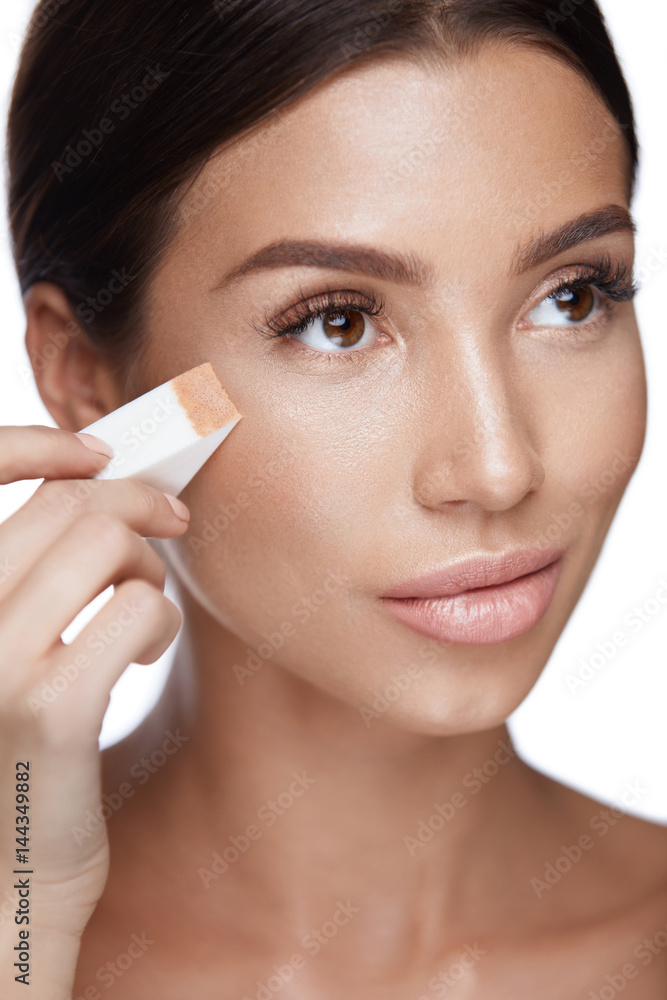 Beautiful Woman Applying Foundation With Sponge. Beauty Face