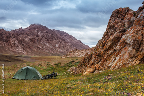 Tent in the mountains. Bicycle trip. Central Asia. Pamir