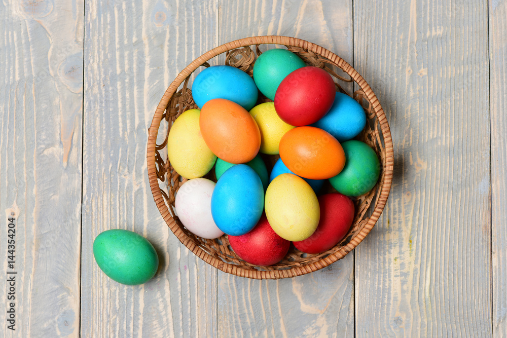colorful painted eggs in basket on wooden background, easter holiday colorful painted eggs in basket on wooden background, easter holiday