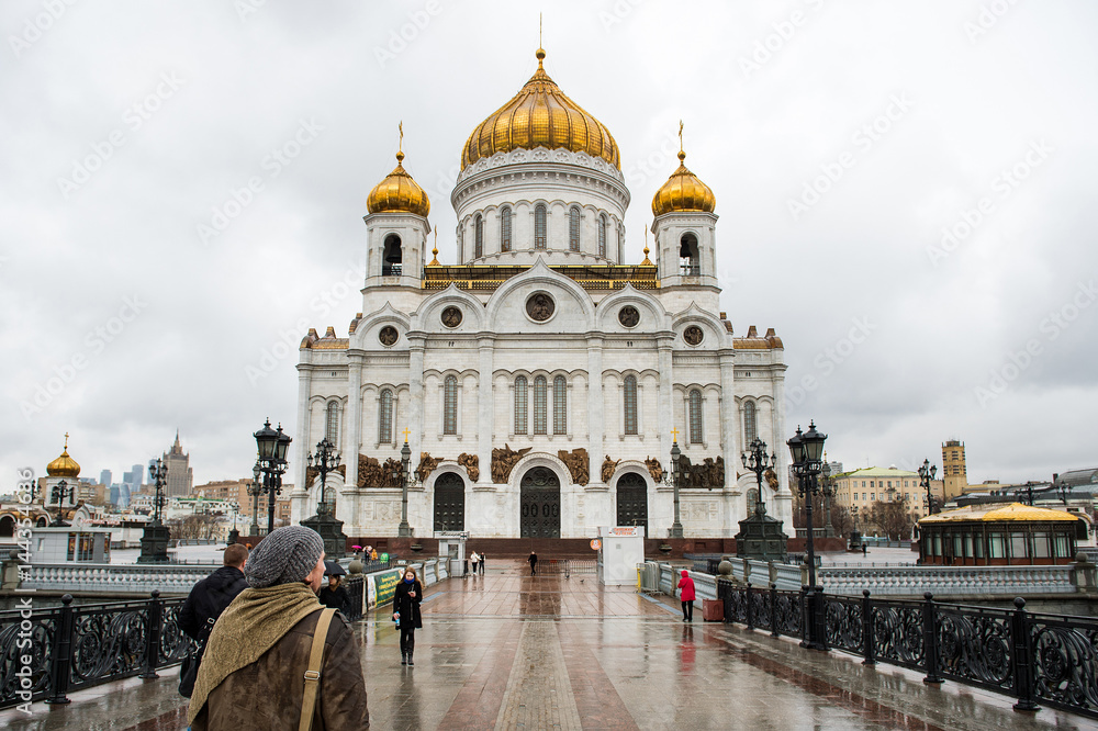 Apr 17, 2015 - Moscow, Russia : tourist walking in front of Cathedral of Christ the Savior on the rainy day.