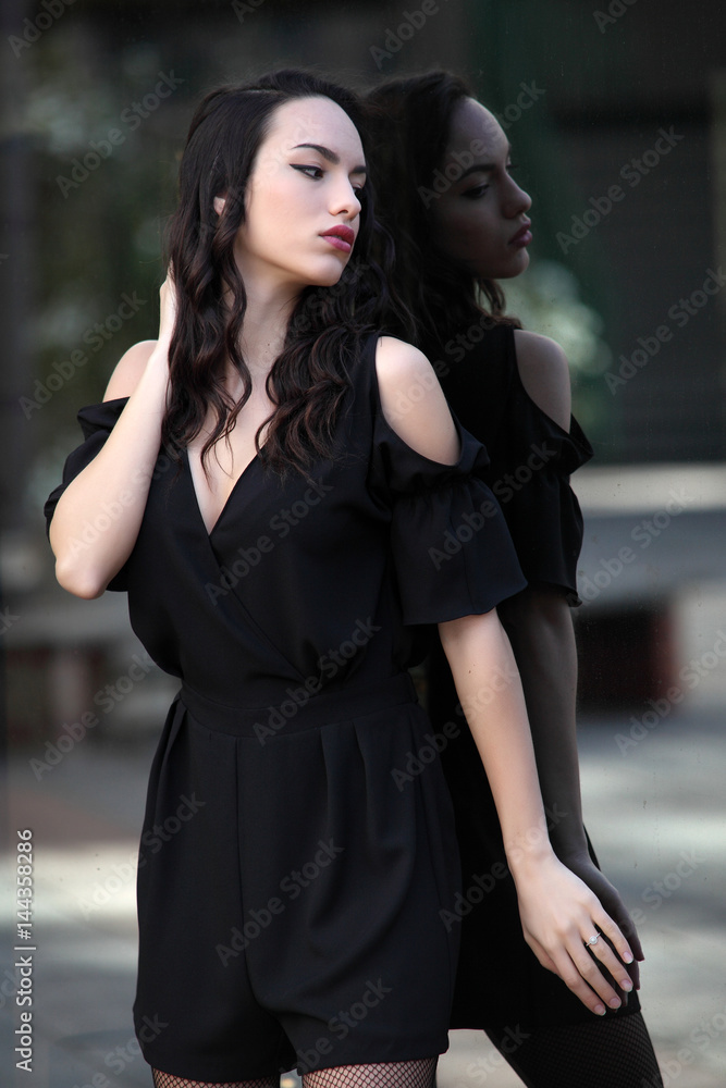 Portrait of young woman looking at the shop window Portrait of young woman looking at the shop window