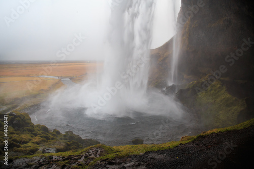 Seljalandsfoss waterfall in southern Iceland on a cloudy winter day. It is one of the largest waterfalls in the country. 