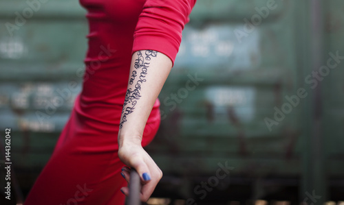 Girl in red dress with tattoo on hand © Viktor