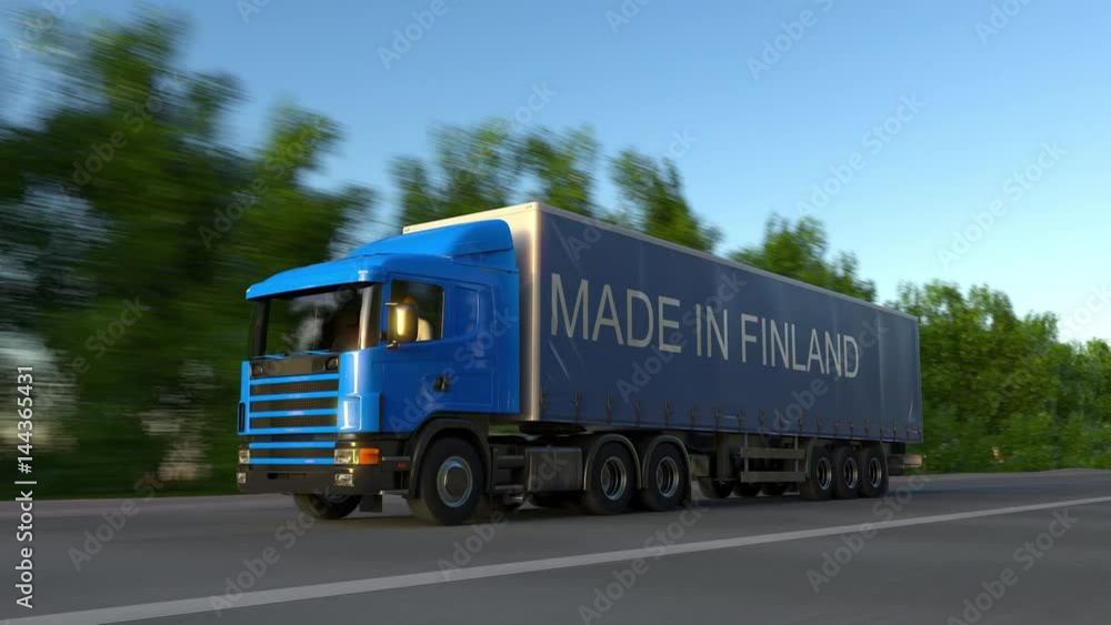 Speeding freight semi truck with MADE IN FINLAND caption on the trailer. Road cargo transportation. Seamless loop 4K clip Speeding freight semi truck with MADE IN FINLAND caption on the trailer. Road cargo transportation. Seamless loop 4K clip