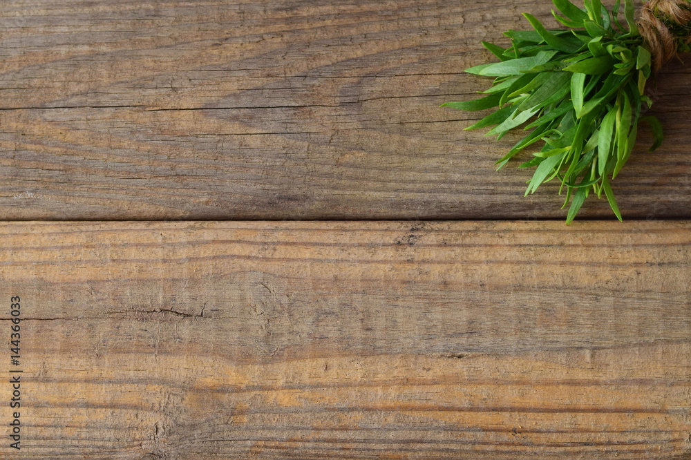 Bunch of fresh tarragon on a wooden background with a space for note Bunch of fresh tarragon on a wooden background with a space for note