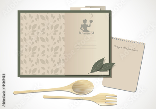 Cookbook with mom's recipes. Wooden spoon and fork and bay leaves