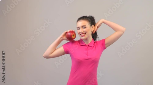 Healthy eating, vegetarian food, dieting and power concept. Young woman young fit female long haired colorful make up holds big red apple fruit