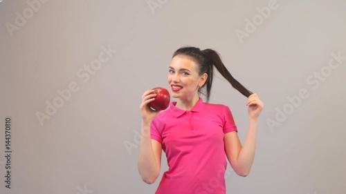 Young woman young fit female long haired colorful make up holds big red apple fruit. Healthy eating, vegetarian food, dieting and power concept