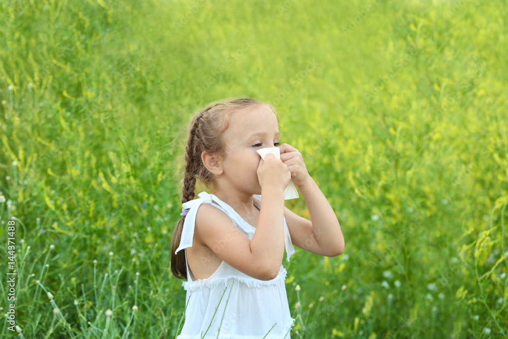 Seasonal allergy. Little girl with tissue outdoor Seasonal allergy. Little girl with tissue outdoor