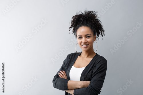Portrait of a confident young woman wearing cardigan photo