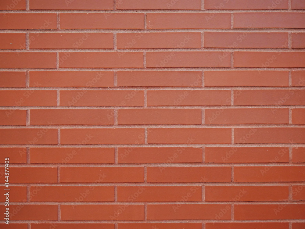 Obraz premium Brown orange brick wall staggered stacked