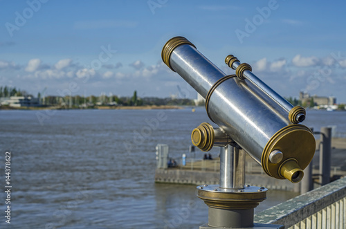 View of the Shelda River from the viewing platform of the wharf of Antwerp. Telescope with landscape