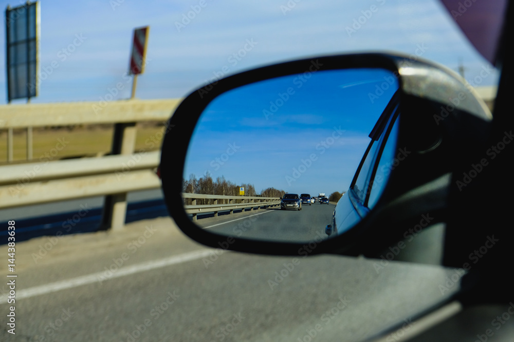 look in the rear view mirror of a car
