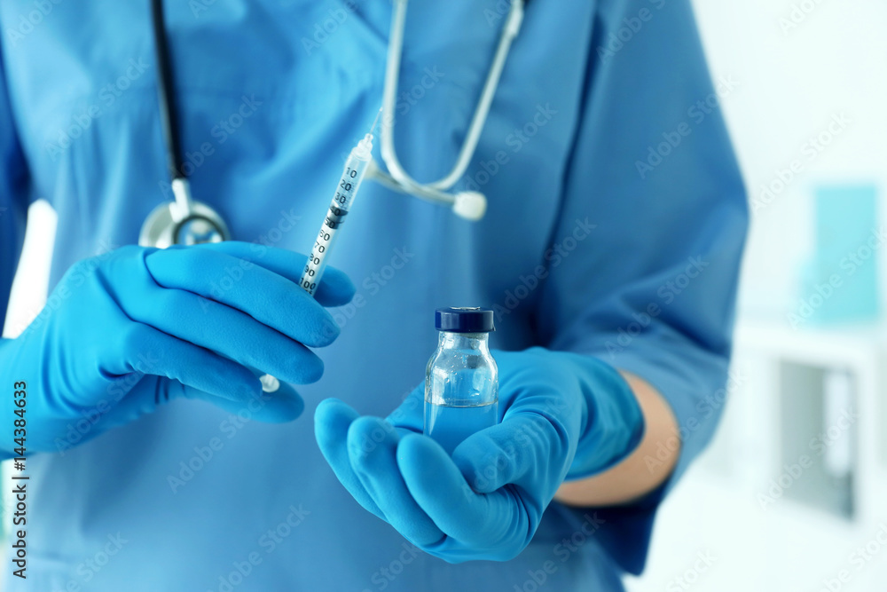 Nurse with syringe and medicine for vaccination, closeup Nurse with syringe and medicine for vaccination, closeup