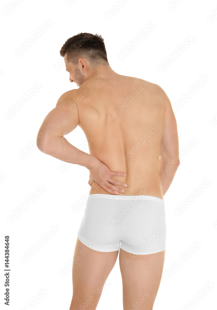 Fototapeta premium Young man suffering from back pain on white background