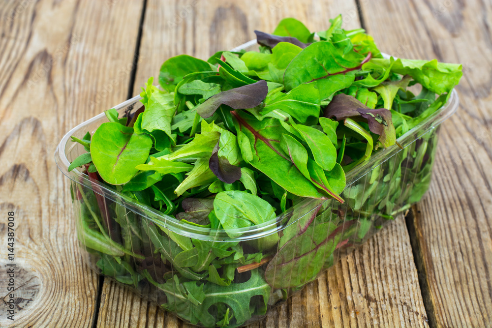 Healthy eating of arugula, mitsuna, chard, red mustard in plasti Healthy eating of arugula, mitsuna, chard, red mustard in plasti
