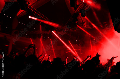 Night club dj party people enjoy of music dancing sound with colorful light with Smoke Machine and lights show. Hands up in the earth. photo