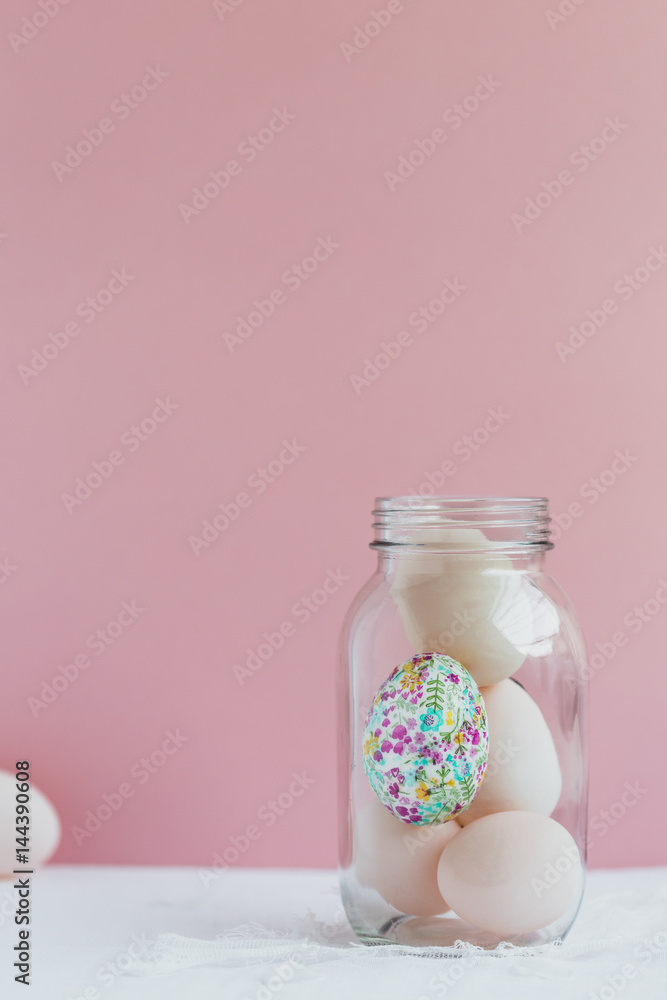 Decorative Egg in Glass Jar with White Duck Eggs against Pink Background Decorative Egg in Glass Jar with White Duck Eggs against Pink Background