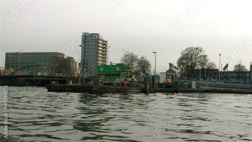 A boat trip on the canals of Amsterdam. De Ruijterkade, IJ bay. photo