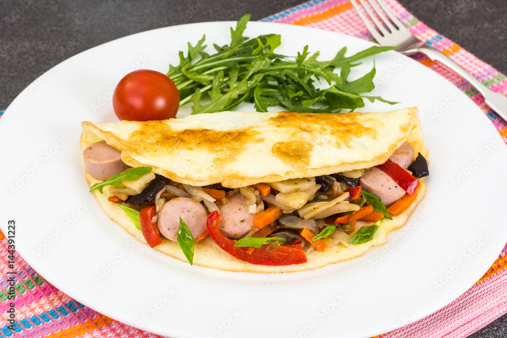 Breakfast omelet with vegetables and sausages Breakfast omelet with vegetables and sausages