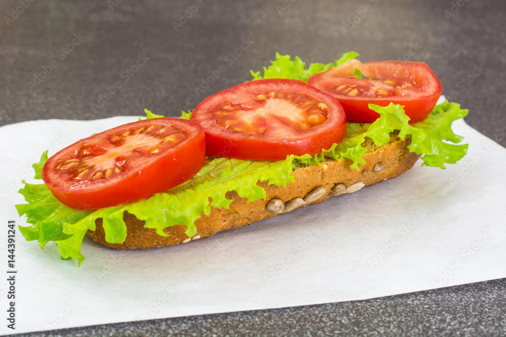 Sandwich with sausage and vegetables on whole grain bread Sandwich with sausage and vegetables on whole grain bread