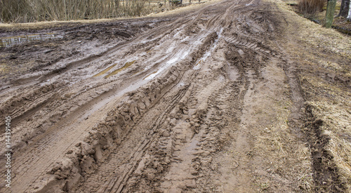Impassable dirt road with ruts and puddles