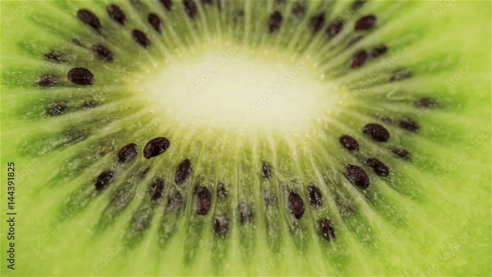 Rotating kiwi slice, macro. Fresh and healthy organic food Rotating kiwi slice, macro. Fresh and healthy organic food