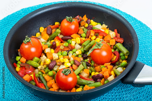 Steamed vegetables with tomatoes in pan