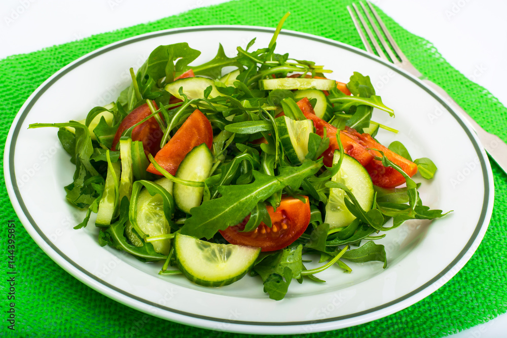 Healthy and diet food: arugula, cucumbers, tomatoes