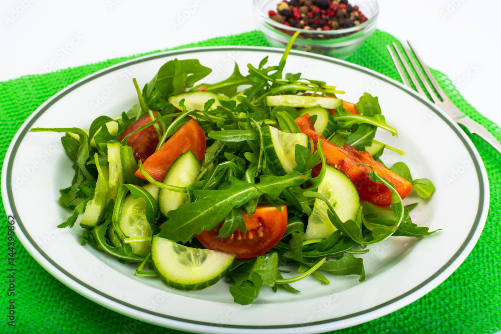 Healthy and diet food: arugula, cucumbers, tomatoes Healthy and diet food: arugula, cucumbers, tomatoes