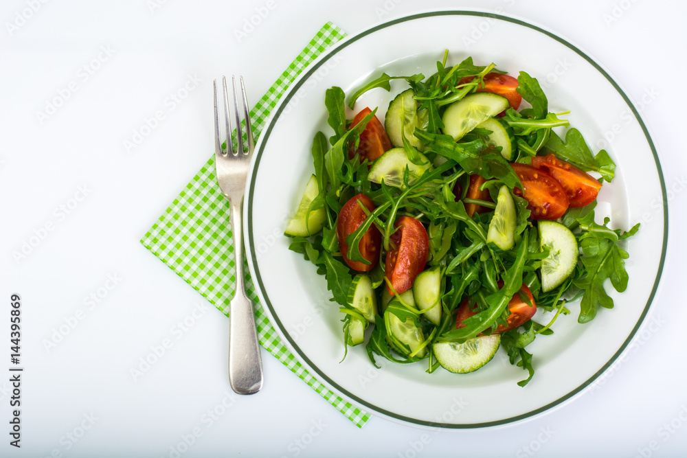 Healthy and diet food: arugula, cucumbers, tomatoes Healthy and diet food: arugula, cucumbers, tomatoes