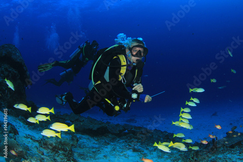 Blonde woman scuba diver explore coral reef in ocean © Richard Carey