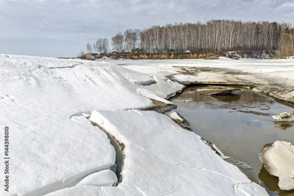 Spring melting of ice on the river. Siberia, Russia