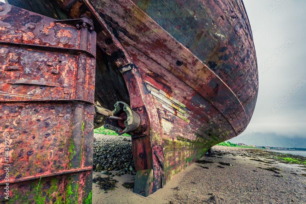 Closeup of abandoned shipwreck on shore in Fort William, Scotland