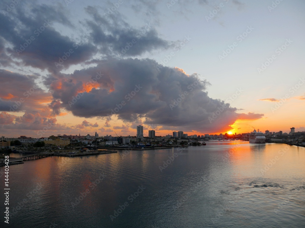 Sunset clouds above Puerto Rico port Heavy clouds hover above the port area of Old San Juan, Puerto Rico at sunset