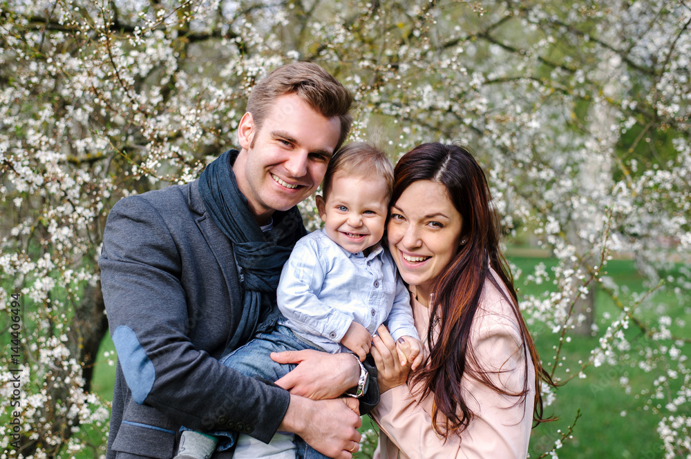 Happy young family walking in a city park Happy young family walking in a city park