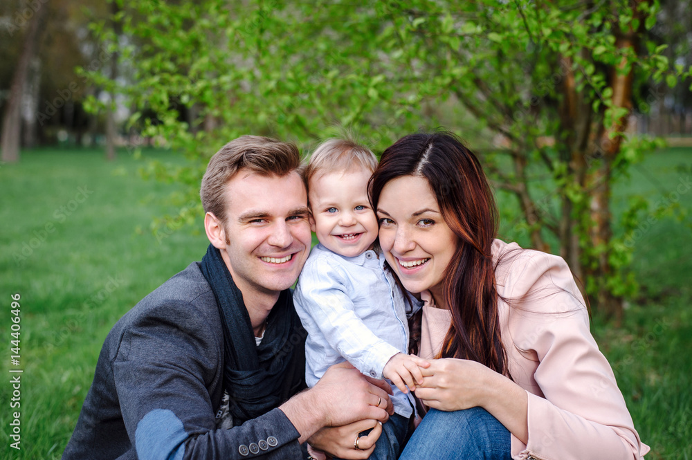 Happy young family walking in a city park Happy young family walking in a city park