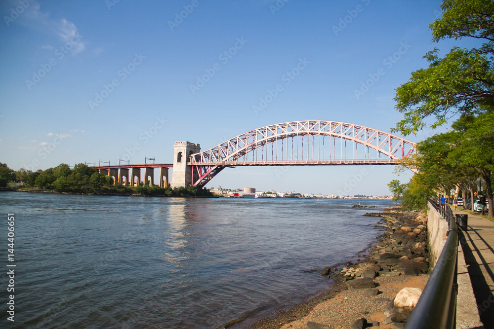 Naklejka premium The Hell Gate Bridge and the shore at Astoria Park, New York