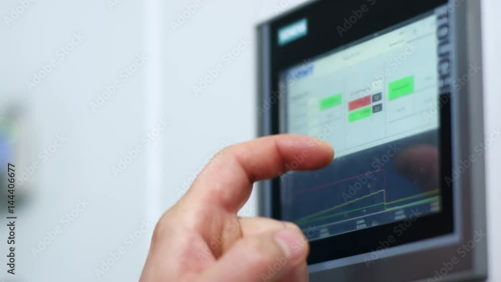 Industry control screen display. Monitor touch screen hand. Factory control system screen. Close up of control monitor system. Male hand touch control screen display. Industrial computer equipment