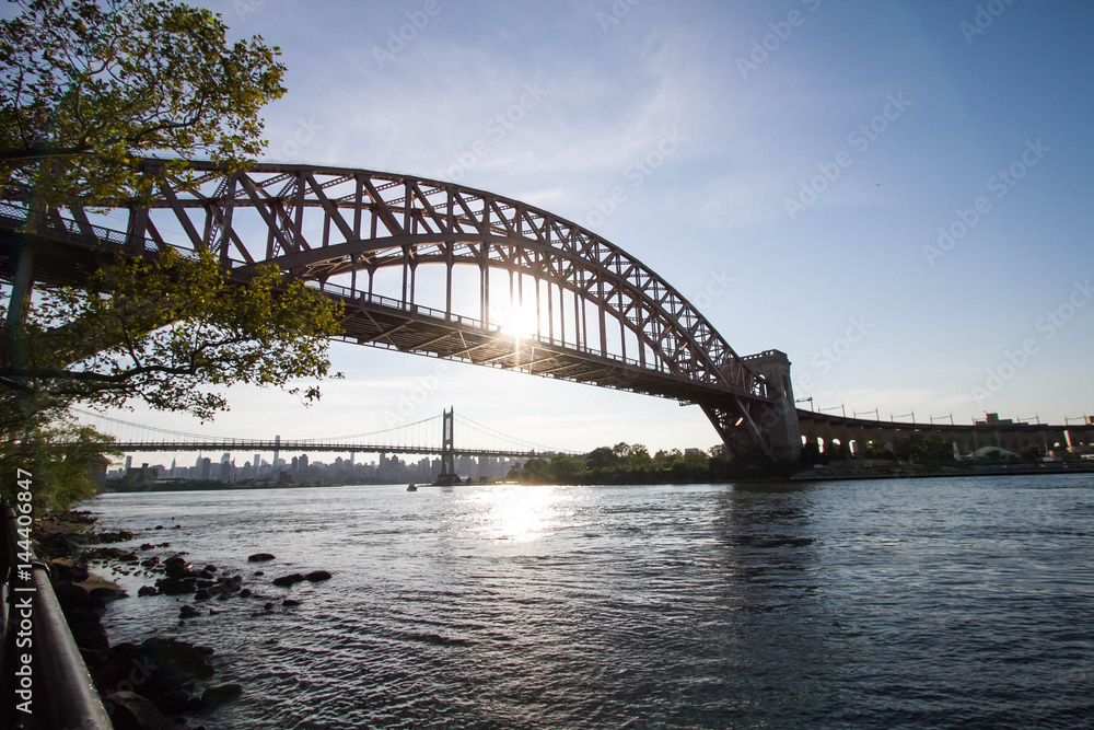 The Hell Gate Bridge and the Triborough bridge over the river with blue sky, Astoria park, New York