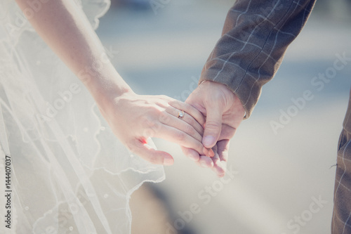 Interracial couple holding hands at wedding